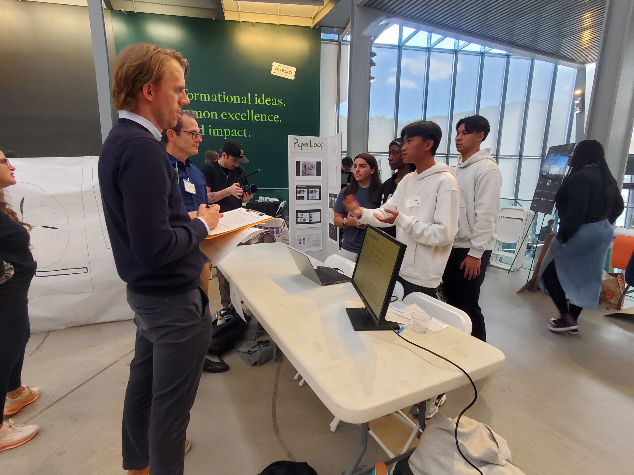 A team demoing their product on a laptop for a visitor